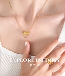 Detail of 18K gold-plated square pendant necklace and hollow statement ring on model