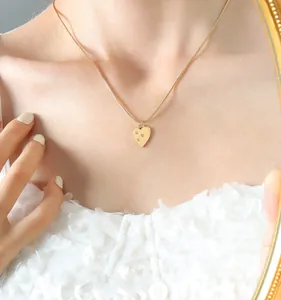 Close-up of 18K gold plated heart pendant necklace with zircon on delicate snake chain