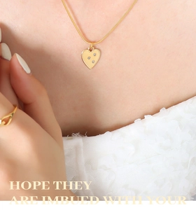 Close-up of 18K gold plated heart pendant with cubic zirconia on a sleek snake chain