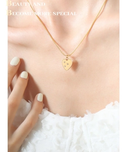 Detailed view of an 18K gold plated heart pendant necklace with zircons on a snake chain