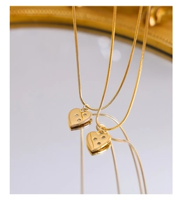 Detail of 18K gold plated heart pendant necklace with zircon inlay on snake chain