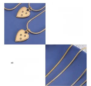 Detail view of 18K gold plated titanium heart pendant necklace with zircon inlays