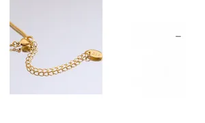 Detail of 18K gold-plated snake chain showing lobster clasp and K18 hallmark engraving