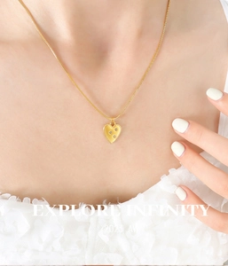 Close-up of 18K gold plated heart pendant necklace with zircon on a sleek snake chain