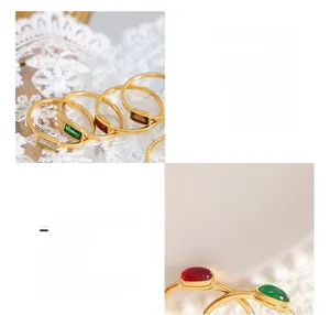 Close-up of 18K gold plated titanium rings with emerald and ruby zircon stones