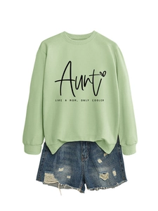 Detail of mint green sweatshirt with Aunt Like A Mom print and distressed denim shorts