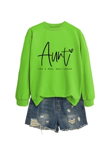 Detail of neon green sweatshirt with Aunt Like A Mom print and distressed denim shorts