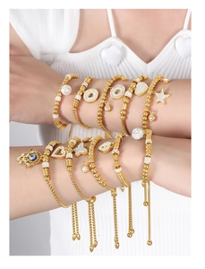 Detail of adjustable 18K gold plated beaded bracelets with Fatima hand and evil eye charms