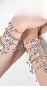 Close-up of layered beaded bracelets with butterfly and evil eye charms on wrist