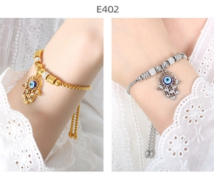Detail of adjustable Hamsa Hand and Evil Eye bracelets in gold and silver plating