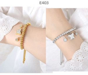 Detail of adjustable 18K gold and silver bracelets with micro-pave butterfly charms