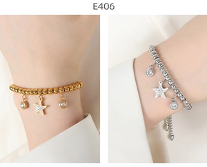 Detailed view of 18K gold and silver beaded star bracelets with sparkling round zircon charms