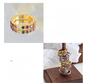 Close-up of titanium steel ring plated in 18k gold with multi-color crystal zircons