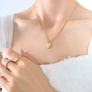 18K gold plated heart pendant necklace with zircon inlay worn by a model
