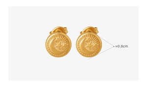 Macro detail of 0.8cm gold titanium earrings with embossed star and moon pattern