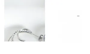 Detail of silver twisted rope double-line C-shaped earrings with 18K gold plating finish