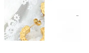 Detailed view of luxury gold C-shape hoop earrings with faux pearl embellishments