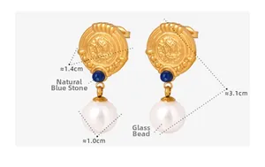 Macro shot of French vintage gold earrings with blue gemstone and glass pearl detail