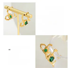 Detail of 18K gold plated titanium heart earrings with oval green glass stones