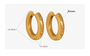 Detailed view of 18k gold-plated wide hoop earrings with star engraving and zircon inlay