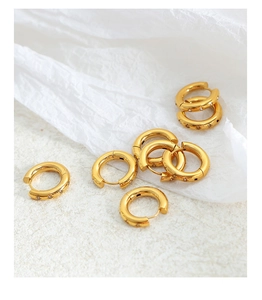 Detail of 18K gold plated hoop earrings featuring engraved stars and zircon crystals