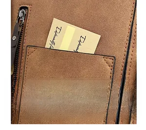 Macro detail of brown frosted leather tote bag showing front pocket and zipper closure