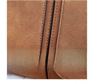 Detailed macro view of caramel frosted suede leather texture with black edge oil finish