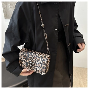 Detail of leopard print shoulder bag with metal chain strap and studded buckle