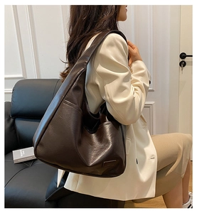 Detail of dark brown faux leather hobo bag showing large capacity and smooth texture