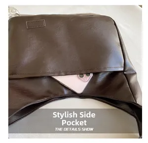 Detail view of the functional side pocket on a vintage brown PU leather tote bag