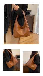 Detail of a large brown hobo tote bag in soft leather texture for daily commute