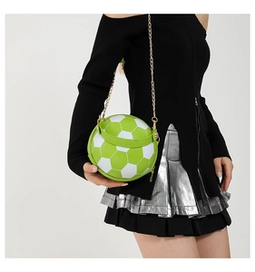 Close-up of creative green and white soccer ball handbag with gold chain strap detail
