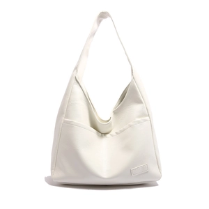 Minimalist white PU leather tote bag with wide shoulder strap and front pocket