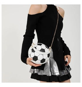 Detailed view of black and white soccer ball crossbody bag with gold chain strap