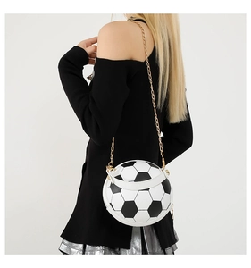 Detailed view of creative football-shaped shoulder bag with golden chain strap on model