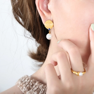 French vintage gold coin earrings with blue lapis lazuli and pearl charms on model