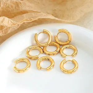 18K gold plated hoop earrings set with sparkling zircon on a white ceramic tray