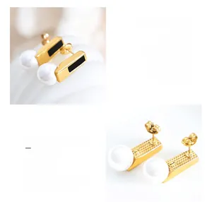 Detail of 18K gold-plated titanium earrings with black inlay and large faux pearl drop