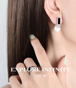 Detail of vintage silver earrings and ring set with black enamel and white pearls