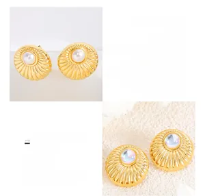 Detailed macro view of 18K gold plated titanium steel earrings with pearls and moonstones