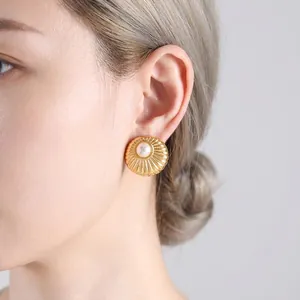 Vintage gold shell pearl earrings with sunburst texture for women, worn on ear lobe