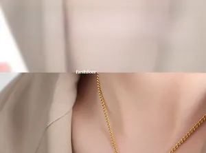 Close-up of minimalist gold square letter pendant necklace on model collarbone