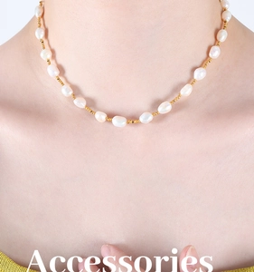 Detail of baroque freshwater pearl necklace with gold beads on neck for elegance