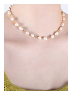 Baroque freshwater pearls and gold beads necklace displayed on a female model's neck