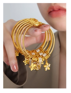 Golden cable bracelets set with butterfly, heart, star charms and zircon details