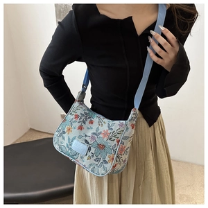 Detailed shot of light blue floral jacquard tote bag with adjustable woven shoulder strap
