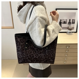 Fashionable leopard print tote bag for women showing spacious size and shoulder fit on model