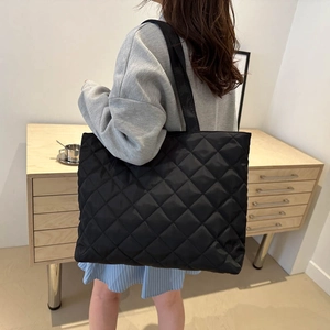Quilted black nylon tote bag for women with large capacity and soft puffer texture