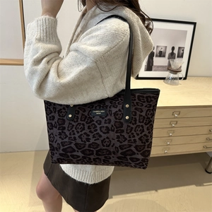 Chic leopard print tote bag with black straps and gold rivets for casual daily fashion