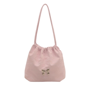 Pink PU leather tote bag with drawstring closure and silver bow ornament on white background